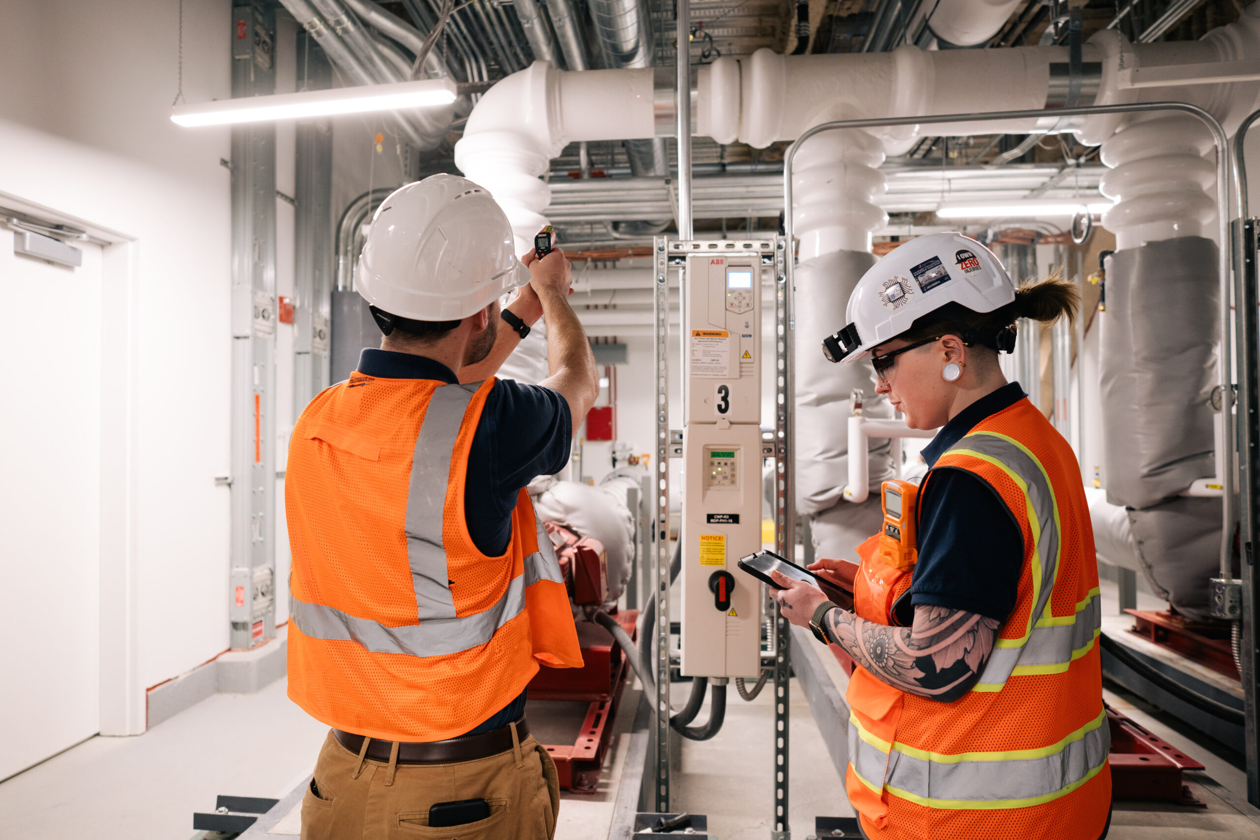 engineers working on buildings pointing temperature gun