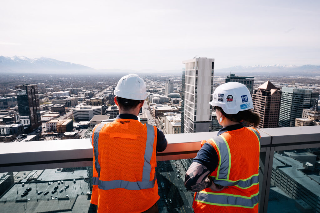 Two engineers on a rooftop looking over the city